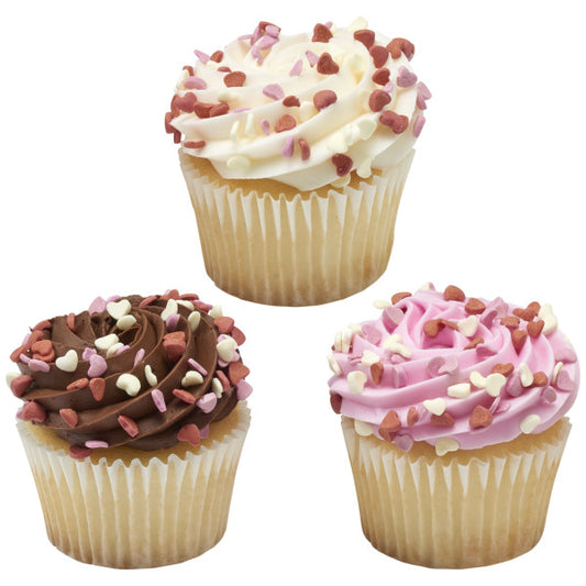 Three cupcakes with white, chocolate, and pink frosting swirls, topped with a mix of red, pink, and white heart sprinkles.