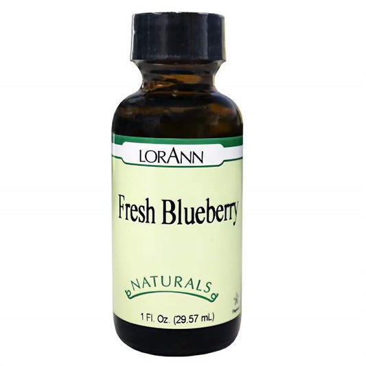 Amber glass bottle of LorAnn Natural Fresh Blueberry Flavor with black cap and pale green label marked “Fresh Blueberry” and “Naturals.” 1 oz bottle for baking and candy making.