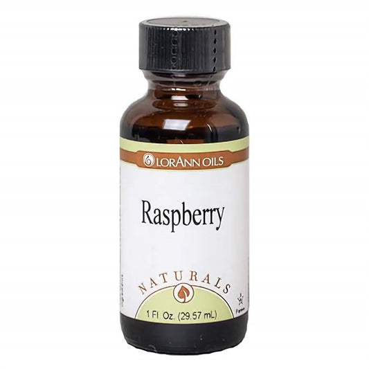 1 fl oz bottle of LorAnn Naturals Raspberry Flavor, alongside vibrant raspberries, capturing the essence of the berries' fresh and tangy sweetness.