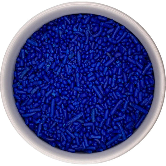 Top-down view of a round container filled with navy blue jimmies sprinkles, showing a dense mix of small rod-shaped pieces in a deep blue shade.