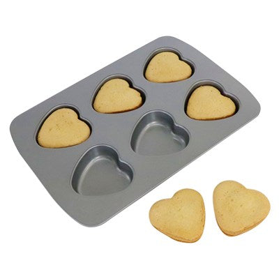 Heart-shaped sponge cakes baked in PME 6 Cup Heart Pan with two cakes displayed in front.