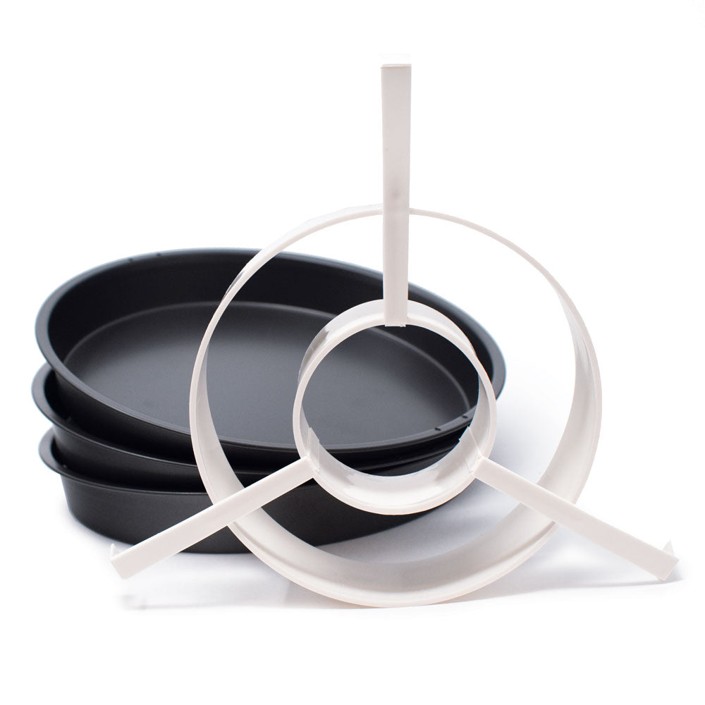 A set of three black nonstick cake pans with a white plastic 3-ring batter divider, designed for making checkerboard cakes.