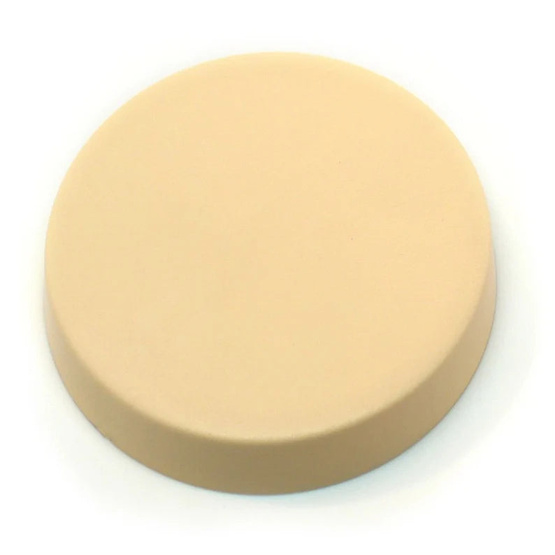 Round beige practice cookie disk with a smooth, matte surface and slightly rounded edge, photographed on a white background.