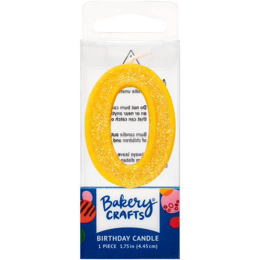 Glittery yellow number zero 1.75" birthday candle in packaging from Bakery Crafts.
