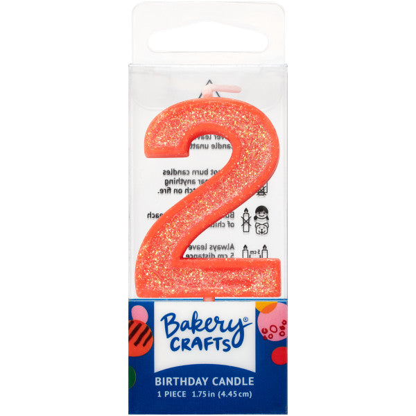 Glittery orange number two 1.75" birthday candle in packaging from Bakery Crafts.