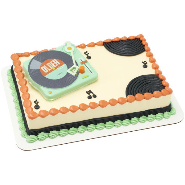 A retro-themed sheet cake featuring the record player topper, fondant records, and musical notes.