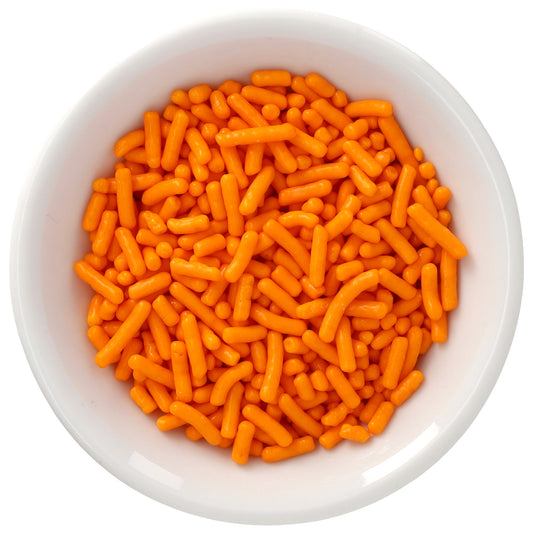 White bowl filled with bright citrus orange Natural Dyed Made Simply™ rod-shaped sprinkles, photographed from above against a white background.