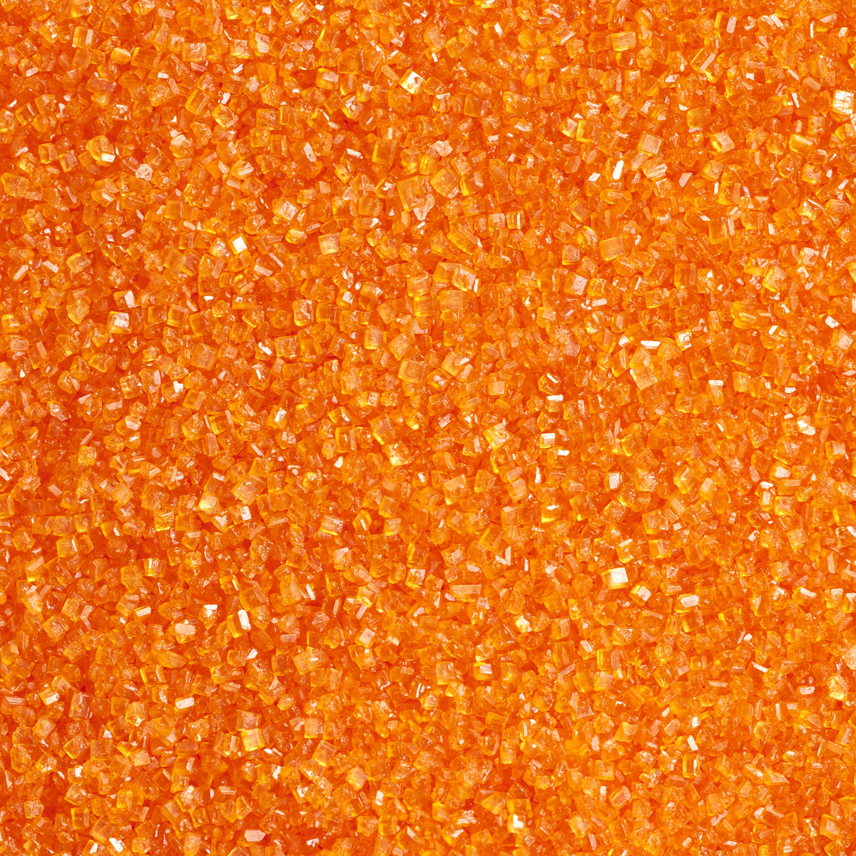 Close-up of vibrant orange sanding sugar showing coarse, translucent orange sugar crystals with a shiny, faceted texture.