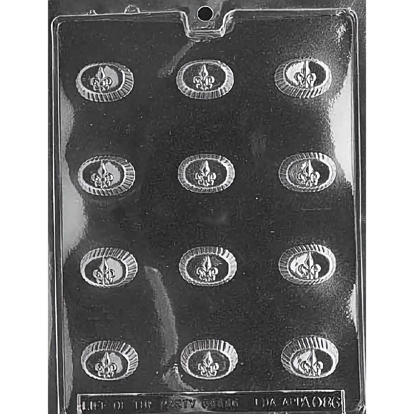 Oval Fleur-de-Lis Chocolate Mold with twelve oval cavities, each featuring a detailed Fleur-de-Lis design surrounded by a textured border. The mold creates 1-3/8 inch by 7/8 inch and 5/8 inch deep chocolate pieces, using approximately 0.3 ounces of chocolate per piece. Made of food-grade plastic and manufactured in the USA.