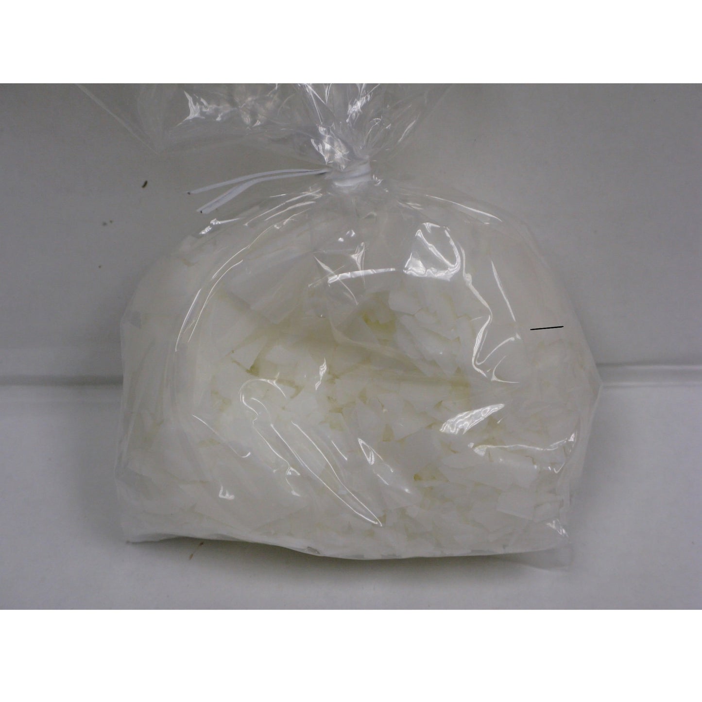 Bag of Paramount Crystals for Chocolate Making - A clear plastic bag filled with white flaky paramount crystals, essential for thinning out chocolate and candy coatings for a smooth and glossy finish in confectionery chocolate
