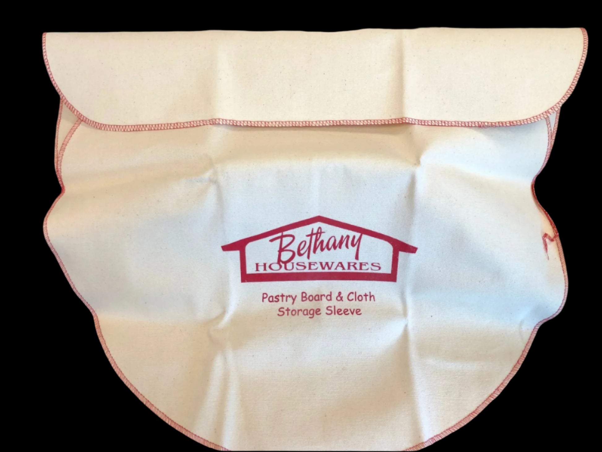 Pastry Board & Cloth Storage Sleeve by Bethany Housewares, made of cream-colored duck twill with red stitching and logo, designed to contain flour and protect baking tools.