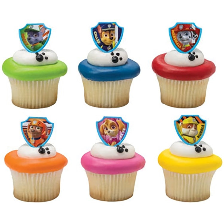 Cupcakes crowned with Paw Patrol shield rings, each featuring a different puppy character, ready to 'ruff' up any kids' party or fan gathering with a rescue mission theme.