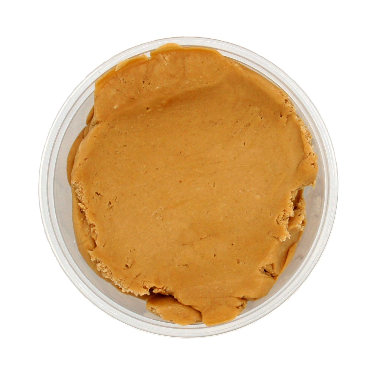 Top-down view of a container filled with peanut butter candy center, showing a smooth and spreadable texture.