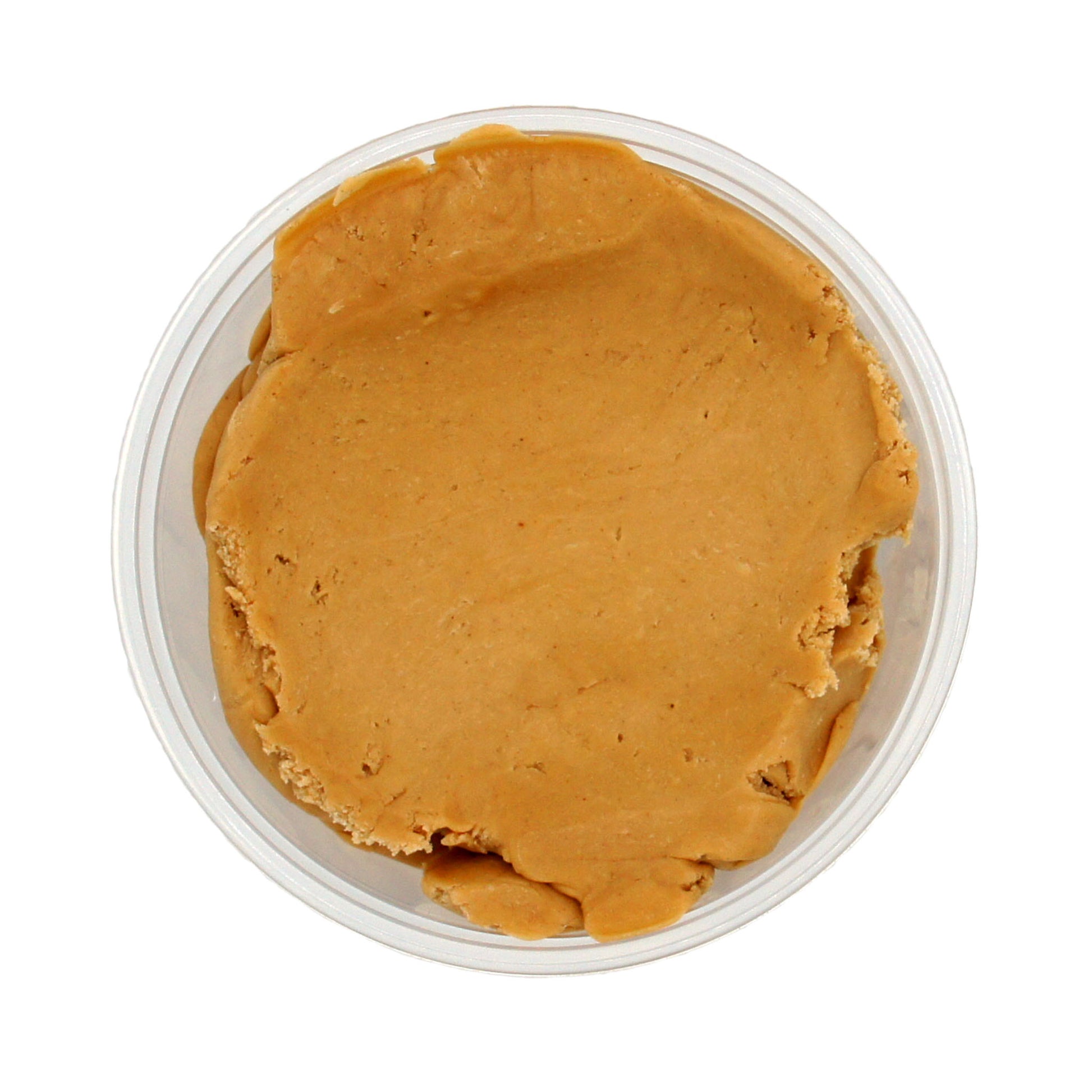 Top-down view of a container filled with peanut butter candy center, showing a smooth and spreadable texture.