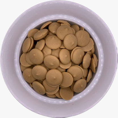 Peanut Butter Flavored Chocolate Confectionery Melting Wafers in a white bowl, embodying the smooth texture and nutty flavor ideal for peanut butter themed treats and decorations.