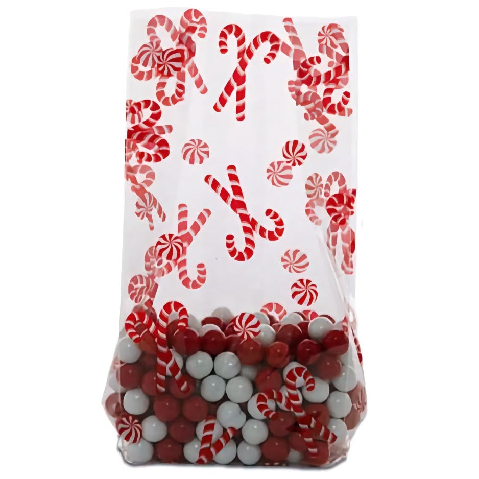 A medium-sized cellophane treat bag filled with red and white candies, with an assortment of peppermint candies and candy canes printed along the upper portion. The festive design features red and white stripes, embodying the classic Christmas candy theme. The transparent bag showcases the colorful candies inside, making it an attractive package for holiday treats.