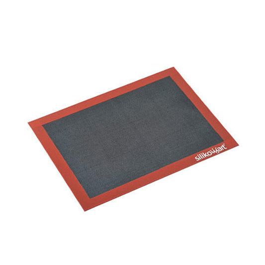 Rectangular perforated silicone baking mat with a dark gray baking surface and a red border, shown at an angle on a white background with a Silikomart logo in the corner.