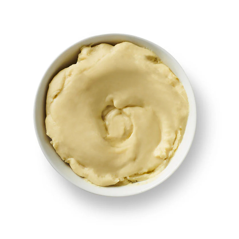 Smooth and creamy cocoa butter in a white bowl, highlighting its natural chocolate aroma and velvety texture, perfect for baking and confectionery use.