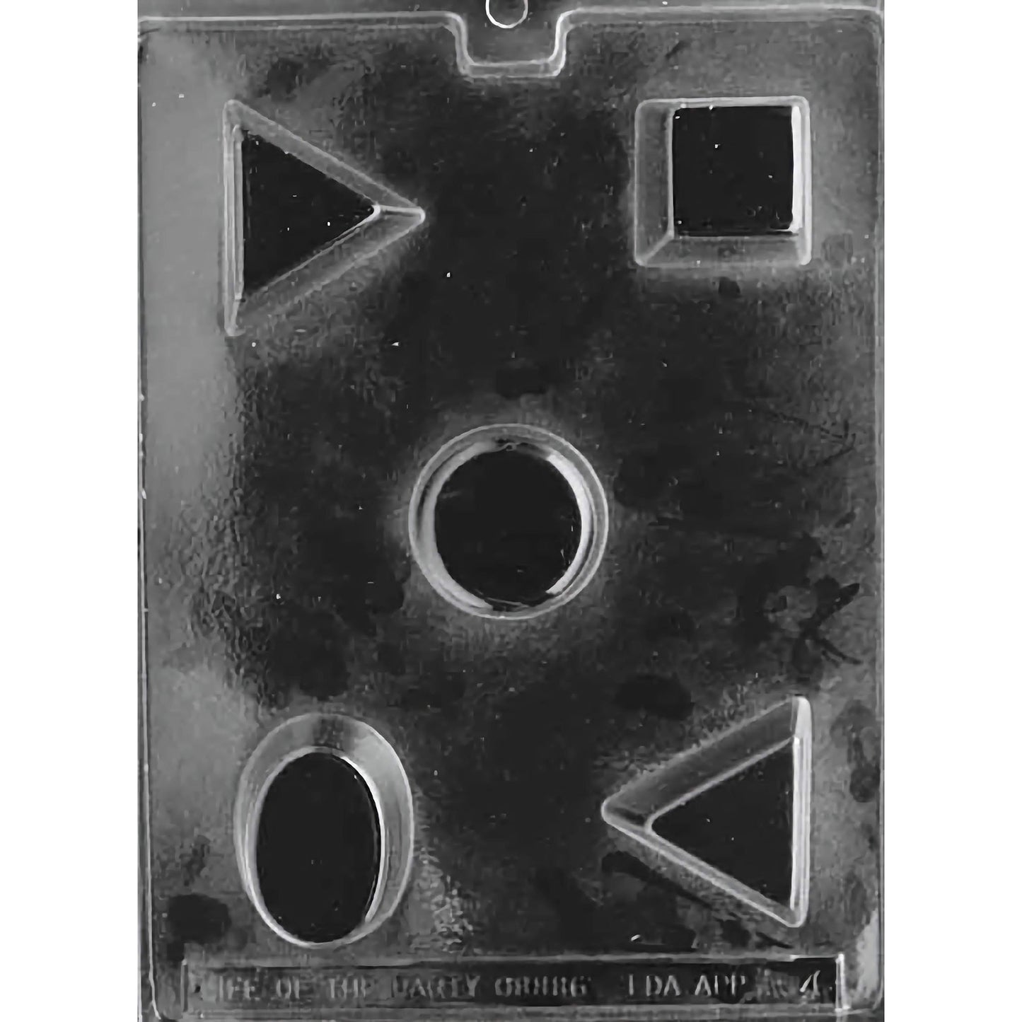 Clear plastic chocolate mold with five distinct cavity shapes: triangle, square, circle, and oval. Mold is shiny and rectangular, designed for creating petite fours or molded chocolates with clean, geometric forms.