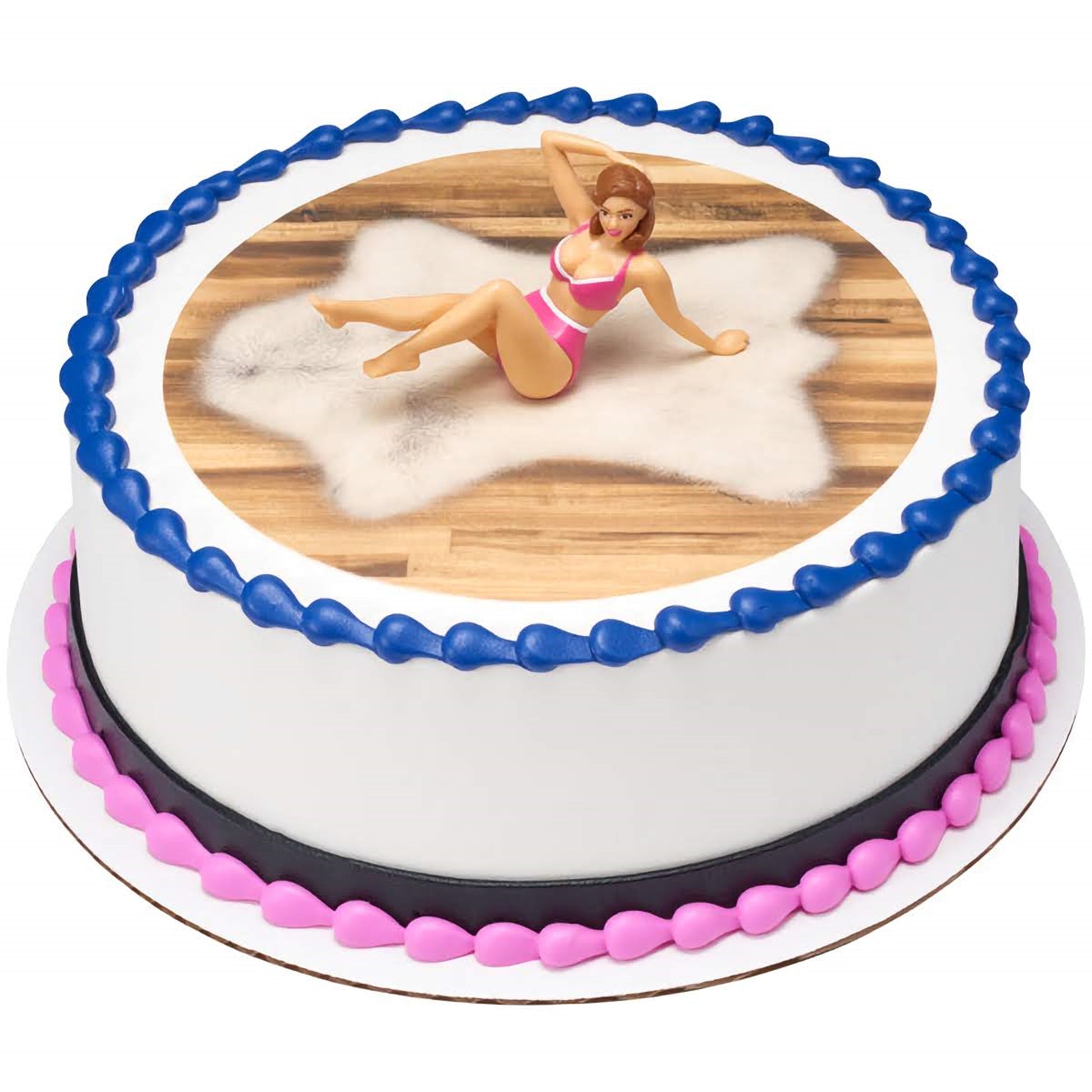 A round cake topped with a 3D topper of a woman in a bikini, set against a white and wood-like icing background with a blue border. This cake, available at Lynn's Cake, Candy, and Chocolate Supplies, is ideal for themed parties looking for a fun and flirty touch.