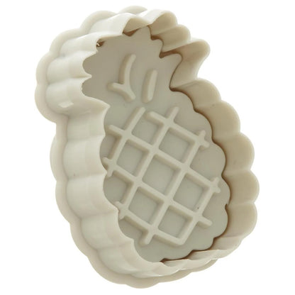 White pineapple-shaped plunger cutter showing the inside embossing plate with crosshatch pineapple detail and leaf shapes, on a white background.