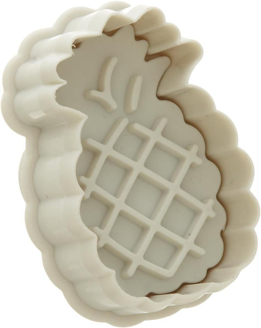 Close-up of a white pineapple-shaped plunger cutter with a ridged outer edge and embossed detailing.