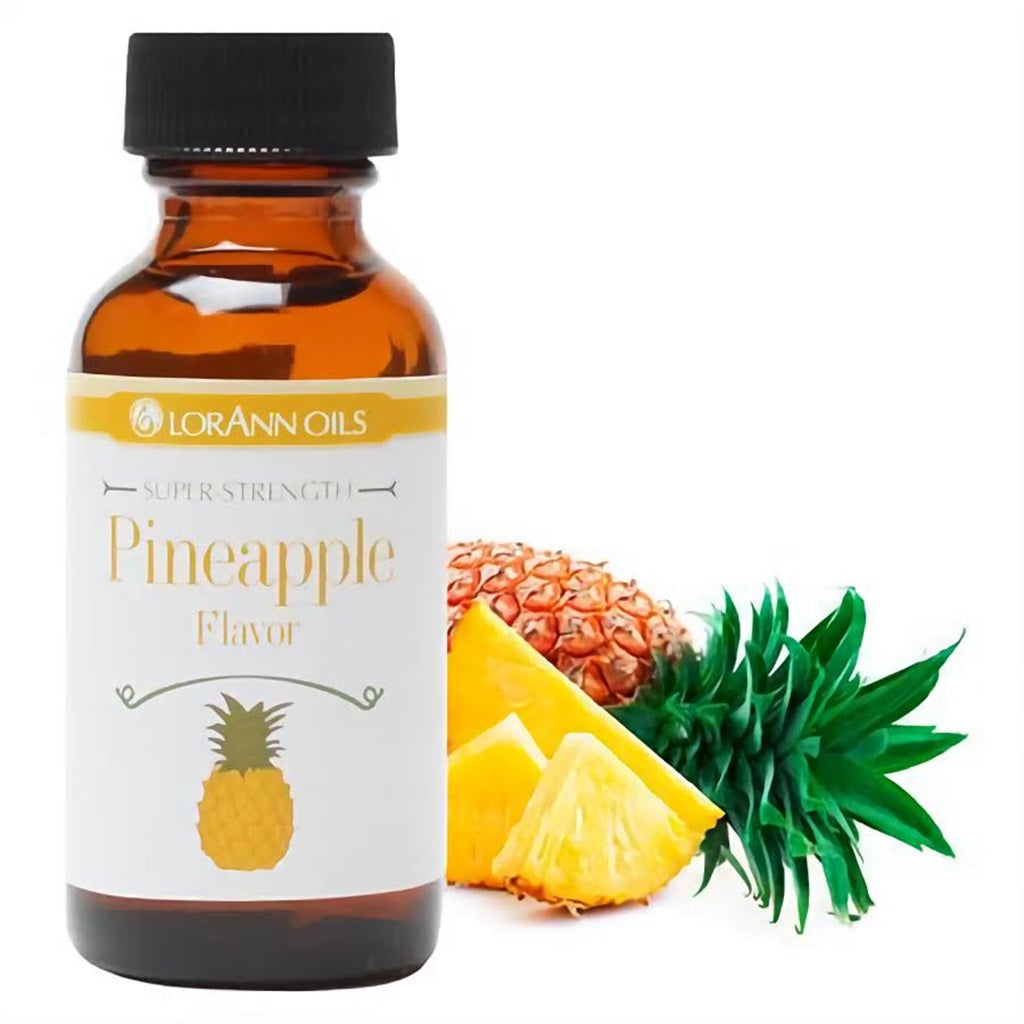 Amber bottle of LorAnn Oils Super-Strength Pineapple Flavor, clearly labeled, alongside fresh pineapple chunks and leaves, evoking the natural, tangy sweetness of the fruit for culinary use.