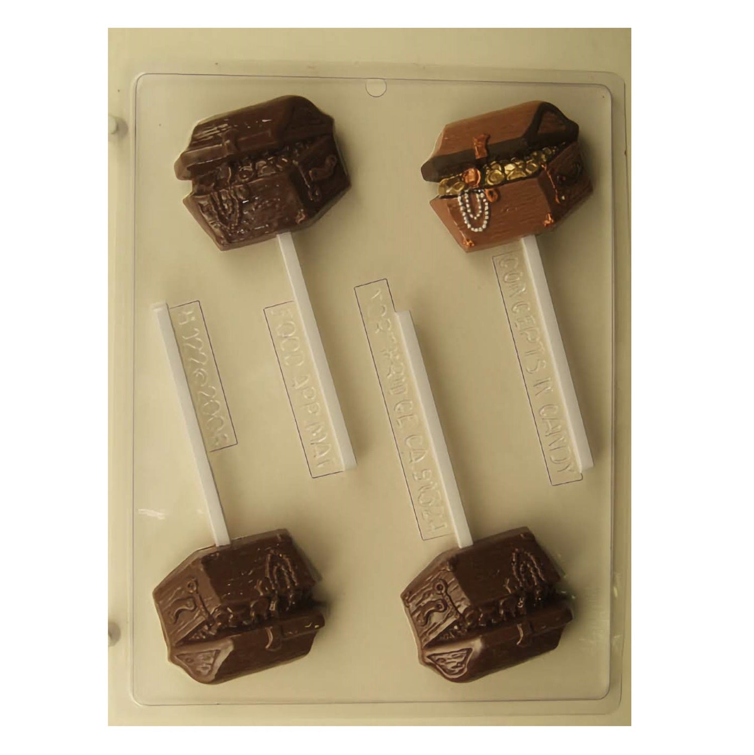 Chocolate mold and finished chocolates resembling ornate pirate treasure chests, complete with intricate lock and wood grain details, and adorned with 'pirate jewels' on one, perfect for themed parties, pirate enthusiasts, or as unique, edible gifts.