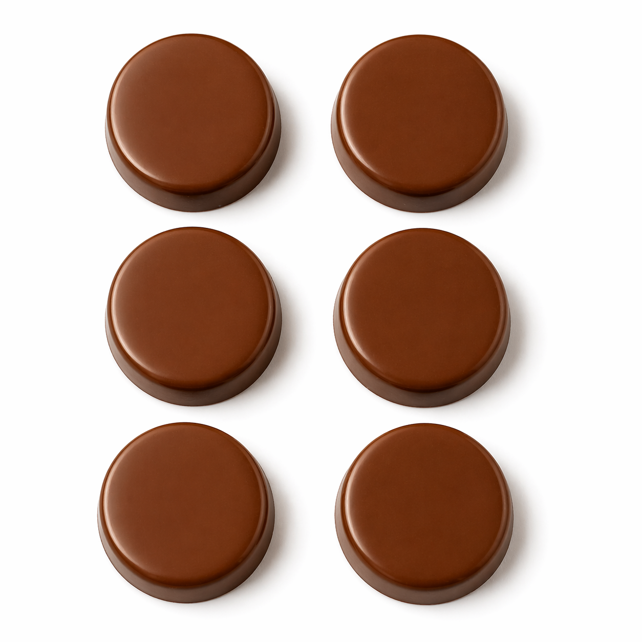 Six plain round chocolate sandwich cookie pieces arranged in two columns on a white background, each with a smooth flat top, rounded edges, and thick puck-like shape.