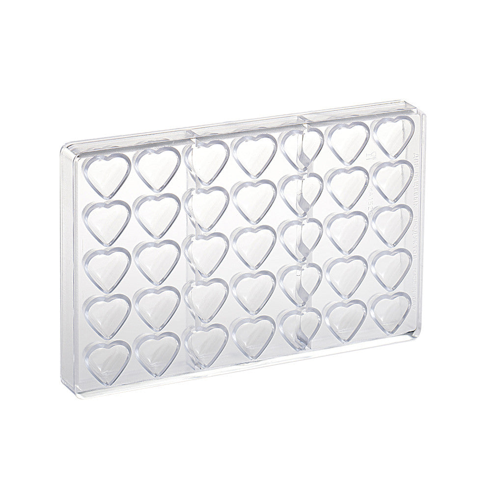 Clear polycarbonate chocolate mold with multiple small heart-shaped cavities arranged in rows, shown on a white background.