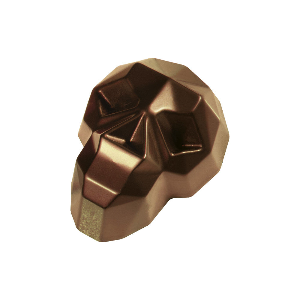 Faceted diamond skull chocolate praline in glossy dark brown with angular geometric features and reflective highlights on a white background