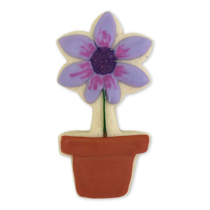 Potted flower cookie decorated with purple petals, a dark center, and a terracotta-colored flowerpot.