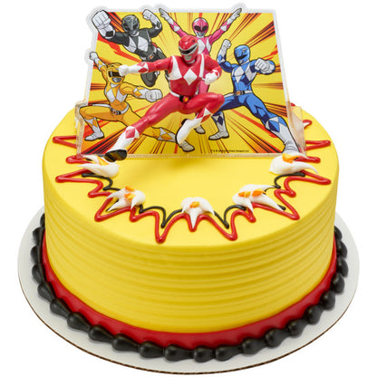 Round yellow cake with red and black trim, topped with Power Rangers Morphin Time Red Ranger figurine and illustrated background.