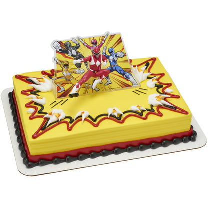 Yellow and red rectangular cake with Power Rangers Morphin Time topper, featuring Red Ranger kicking pose in front of dynamic comic-style background.