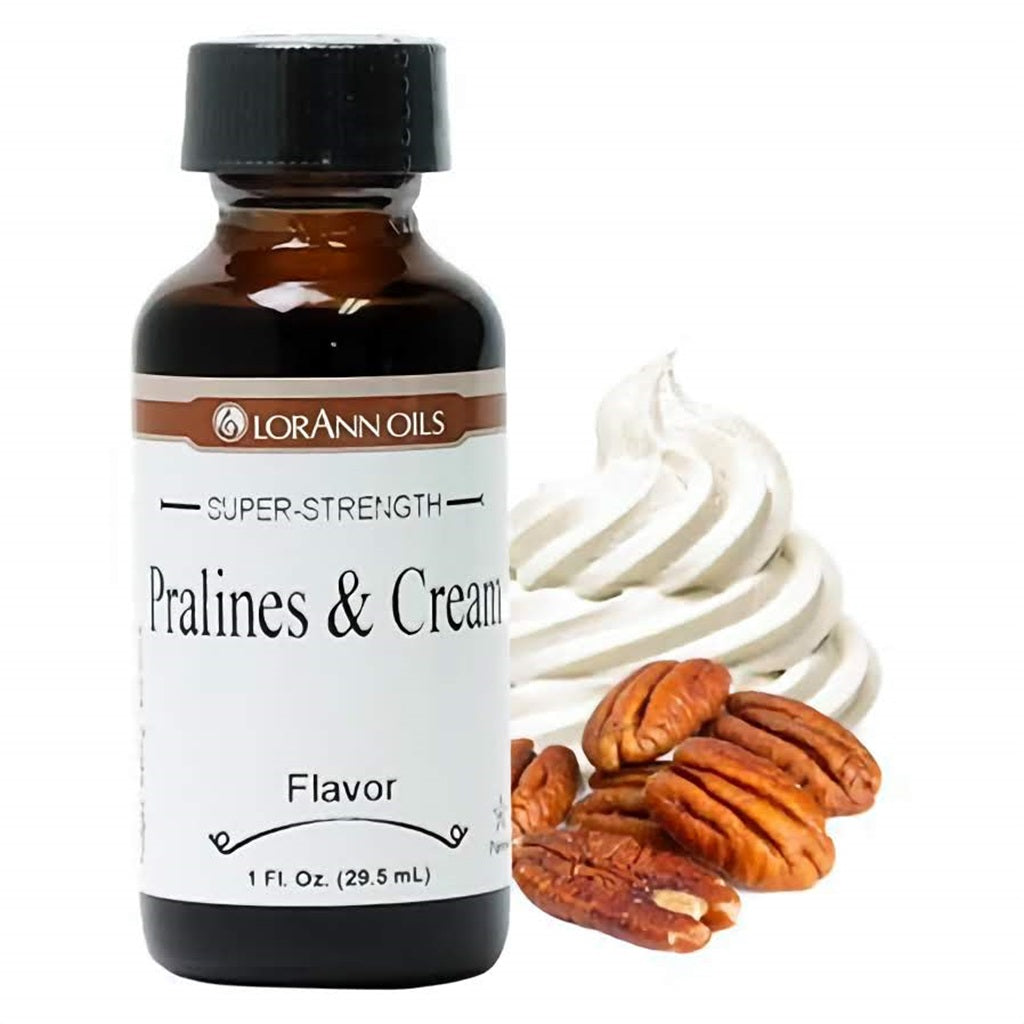 LorAnn Oils Super-Strength Pralines & Cream Flavor in a brown glass bottle, with a swirl of cream and praline nuts beside it, perfect for rich, creamy baking recipes.