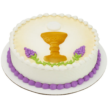 First Communion cake decorated with a pressed sugar chalice, host, and grape accents.