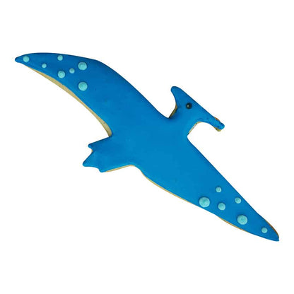 Pterodactyl-shaped sugar cookie decorated with bright blue icing, small circular details on the wings, and a black icing dot for the eye.