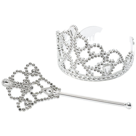 Close-up of silver crown and scepter cake toppers with gem-style detailing