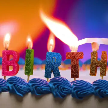 A fully decorated birthday cake with Quick-Light glitter rainbow candles igniting in a chain-reaction effect.