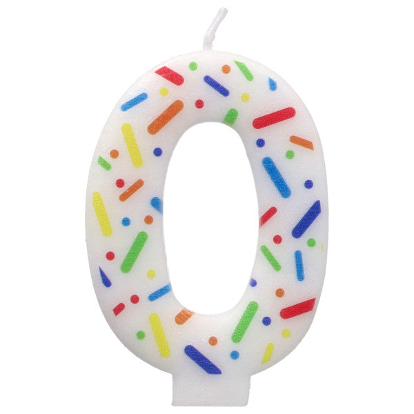 Candle shaped like the number 0 with colorful sprinkles on a white background