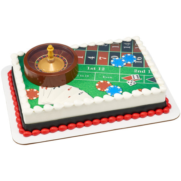 A sheet cake decorated like a roulette table with poker chips and playing cards.