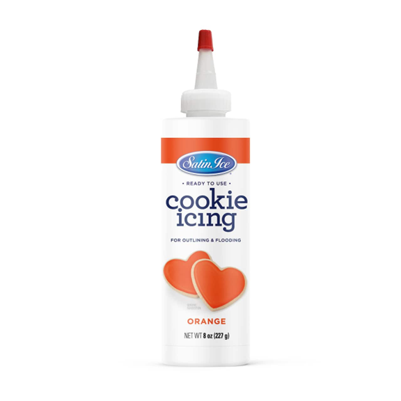 Satin Ice Ready-to-Use Orange Cookie Icing in an 8 oz bottle with a precision nozzle, featuring a bright orange label and decorated heart-shaped cookies.