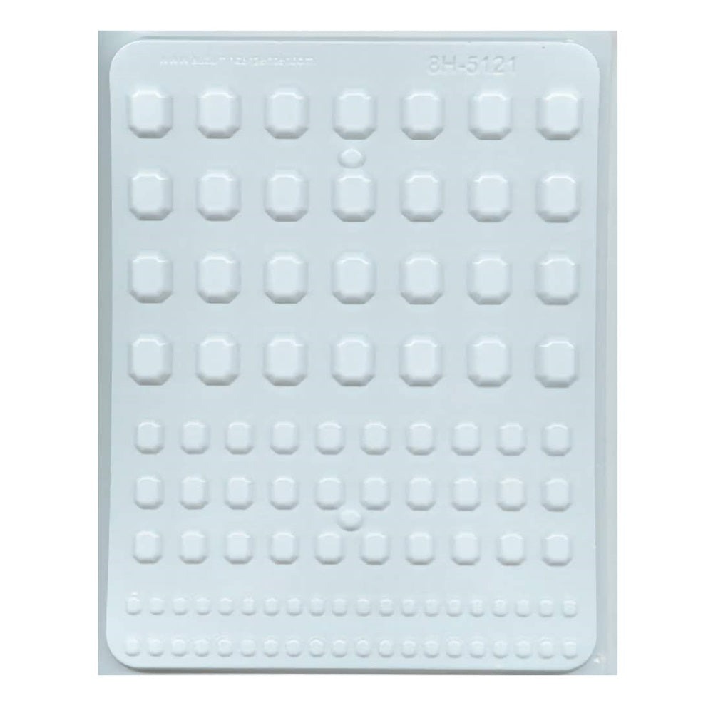 An image of a white plastic hard candy mold designed for creating assorted rectangular gem-shaped candies. The mold contains multiple rows and columns of cavities, each with a faceted gem design, capturing the light and shadow to suggest depth and dimensionality. The cavities are arranged in a grid pattern, with the smallest gems at the bottom row gradually increasing in size towards the top.
