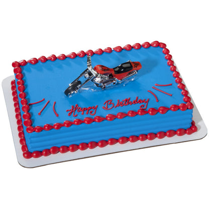 Blue frosted cake with red trim and red chopper motorcycle topper.