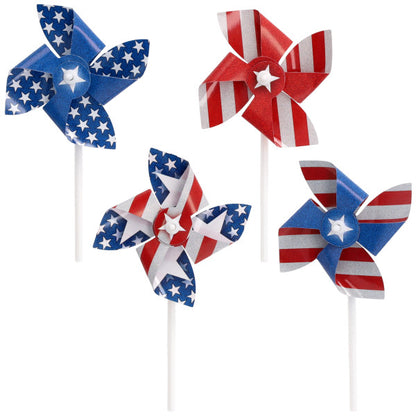Assorted red, white, and blue pinwheel cupcake picks with stars-and-stripes patterns, each on a white stick, shown on a white background.