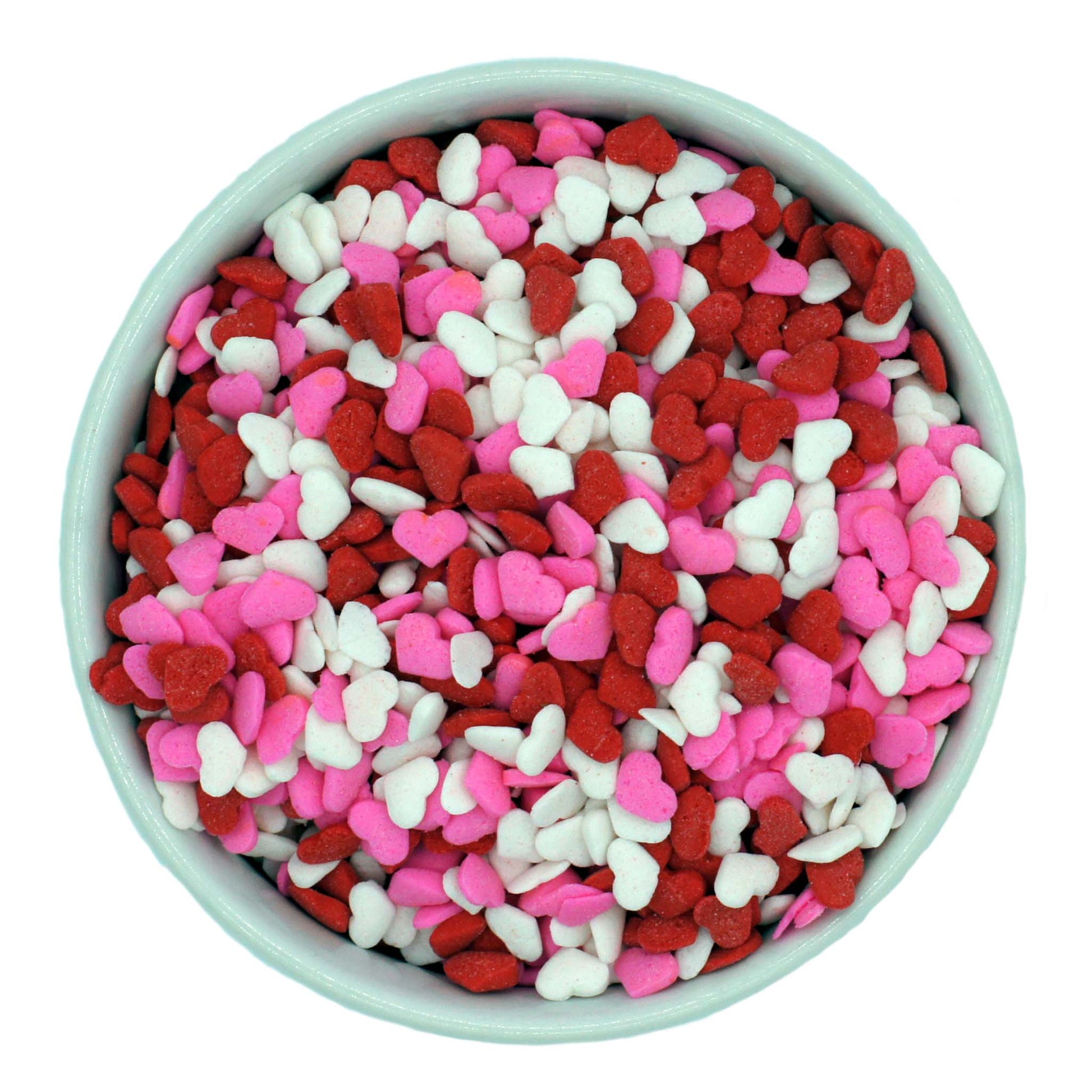 Bowl of red, white, and pink heart-shaped sprinkles for Valentine's Day desserts.