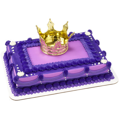 A royal-themed cake with purple frosting, featuring the gold crown centerpiece.