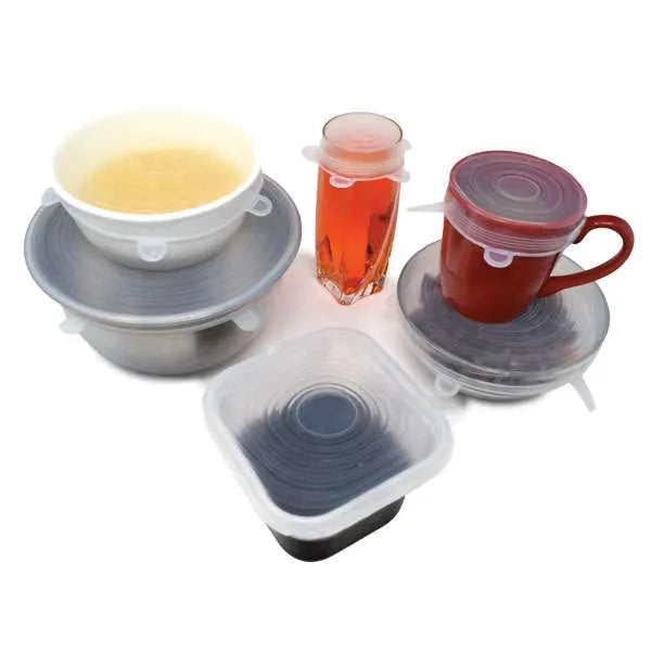 Reusable silicone lids in action, sealing various containers, including bowls, mugs, and glasses, to keep food fresh and spill-free.