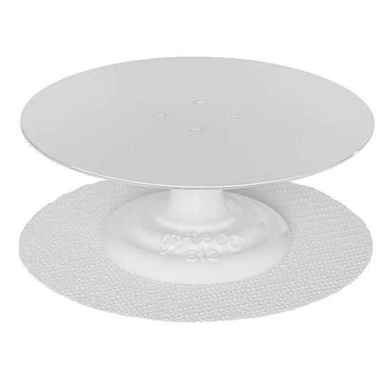 Professional cake turntable with a 12-inch aluminum top and white cast iron base, shown with included non-slip pad underneath for added stability.