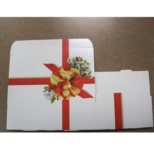 The image shows a 1.5-pound candy box with a white base and a decorative red ribbon graphic printed across it, giving the appearance of a wrapped gift. On the center of the larger box, there's a graphic of a yellow bow with holly and berries, enhancing the festive look. This box design is typically used for holiday treats and presents, adding a seasonal touch to the packaging.